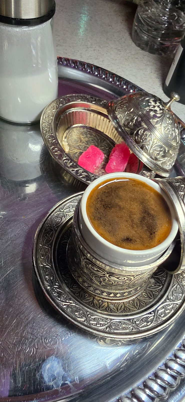 Turkish coffee in an engraved silver cup with Turkish delight