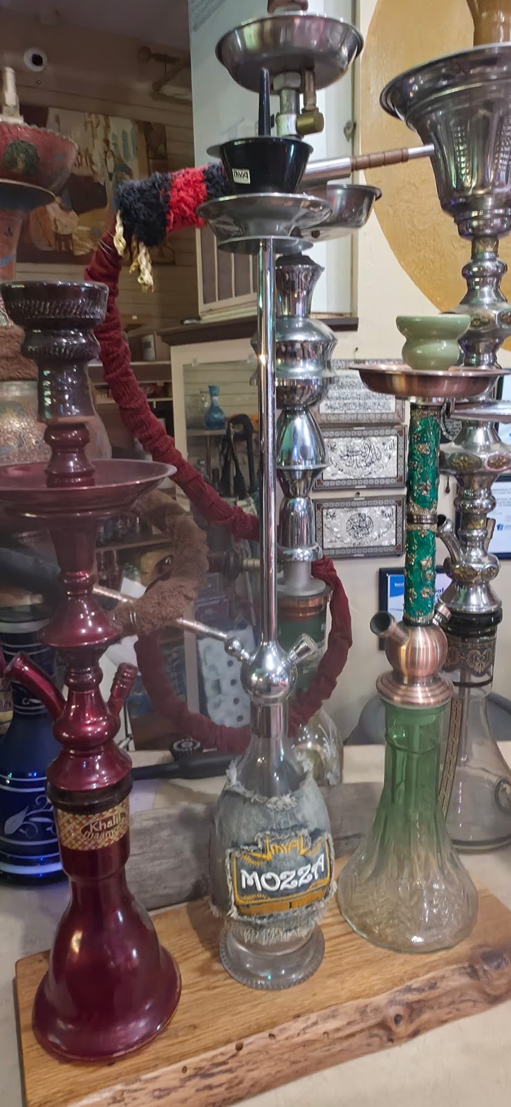 Three vintage hookahs on a wooden board